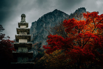 Low angle view of statue against sky during autumn