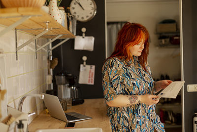 Woman standing in kitchen