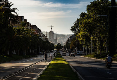 Road by city against sky