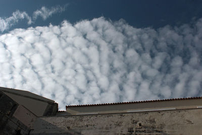 Low angle view of building against cloudy sky