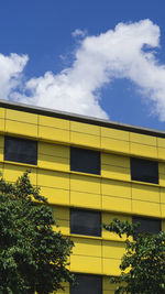 Low angle view of yellow building against sky