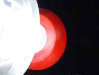 Close-up of red light over black background