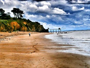 View of beach against cloudy sky