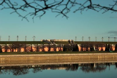 Reflection of trees in lake against clear sky