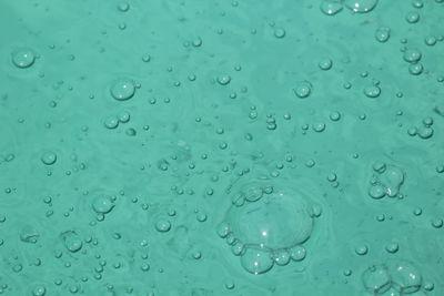 Full frame shot of raindrops on blue surface