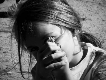 Close-up portrait of girl holding flower