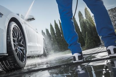 Low section of man washing car