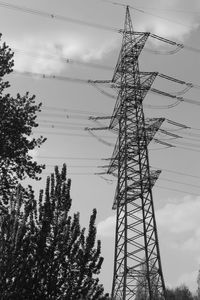 Low angle view of electricity pylon against sky