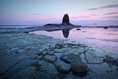 Scenic view of sea against sky at sunset