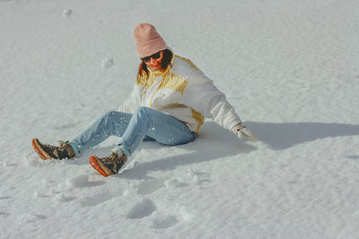 Full length of woman skiing on snow