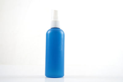 Close-up of blue bottle against white background