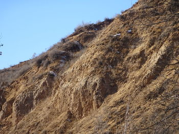 Low angle view of rock formations against sky