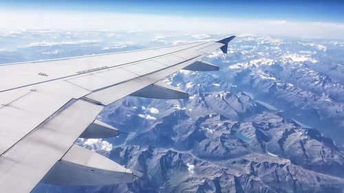 Aerial view of snowcapped mountains against sky
