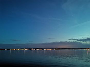 Scenic view of sea against blue sky at dusk