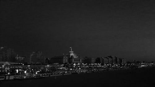 Illuminated city against sky at night