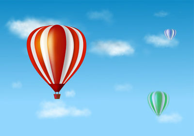 Multi colored hot air balloon flying against blue sky