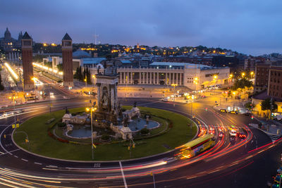 High angle view of illuminated city against sky at dusk