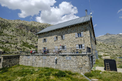 Exterior of building by mountains against sky