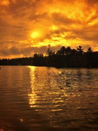 Scenic view of lake against sky during sunset