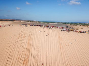 High angle view of crowd on beach against sky