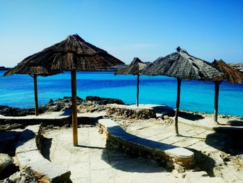 Built structure on beach against clear blue sky