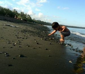 Full length of girl standing on beach