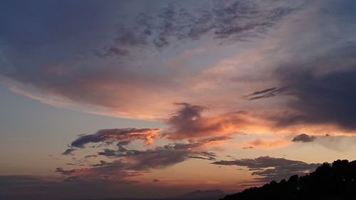 Low angle view of silhouette mountain against dramatic sky