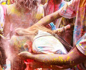 Man applying color to woman during holi
