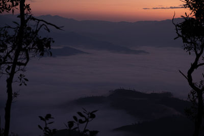 Scenic view of silhouette mountains against sky at sunset