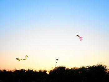 Low angle view of parachute against clear sky