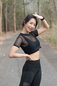 Portrait of a smiling young woman standing outdoors