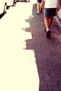 Low section of woman standing on tiled floor