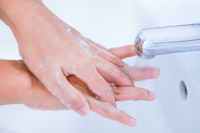 Close-up of hand holding hands in water