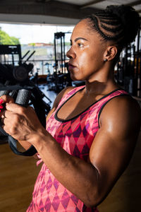 Muscular woman working out in a gym. fitness exercise in the studio.