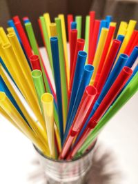 High angle view of multi colored drinking straws on table