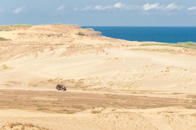 High angle view of desert by sea against sky