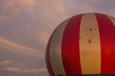 Cropped image of hot air balloon against cloudy sky during sunset