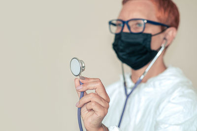 Midsection of man holding eyeglasses