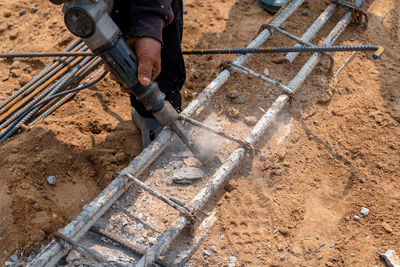 Low section of man working on field