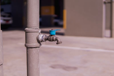Close-up of faucet on pole against blurred background