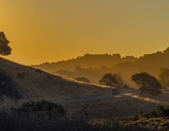 Scenic view of landscape against clear sky during sunset