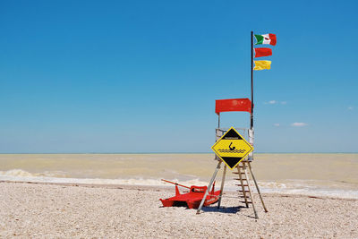 Lifeguard hut on beach against clear sky