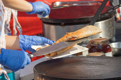 Demonstration cooking, chef making pancakes at naplavka street food market.