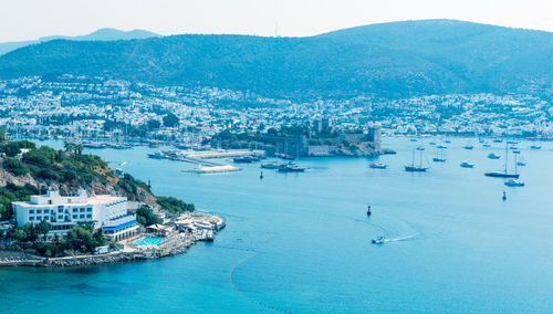 High angle view of townscape by sea against sky