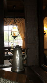 Electric lamp hanging on table at home