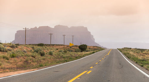 Country road against sky