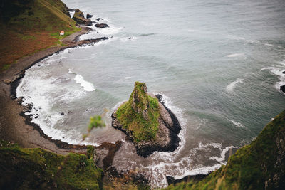 High angle view of rocks on sea shore