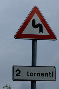 Low angle view of road sign against sky