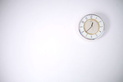 Low angle view of clock on wall