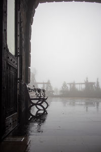 Abandoned building by canal against sky